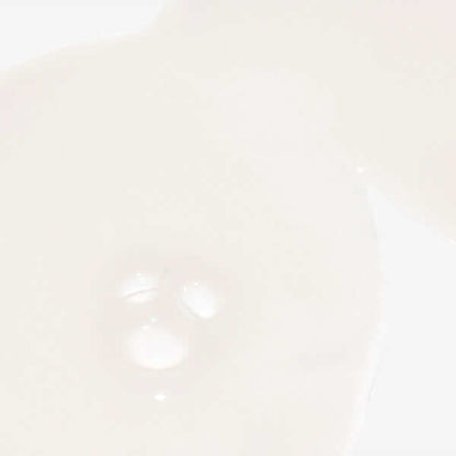 Creamy Fortify cooling enzyme scalp treatment on a clear glass dish against a pale background.