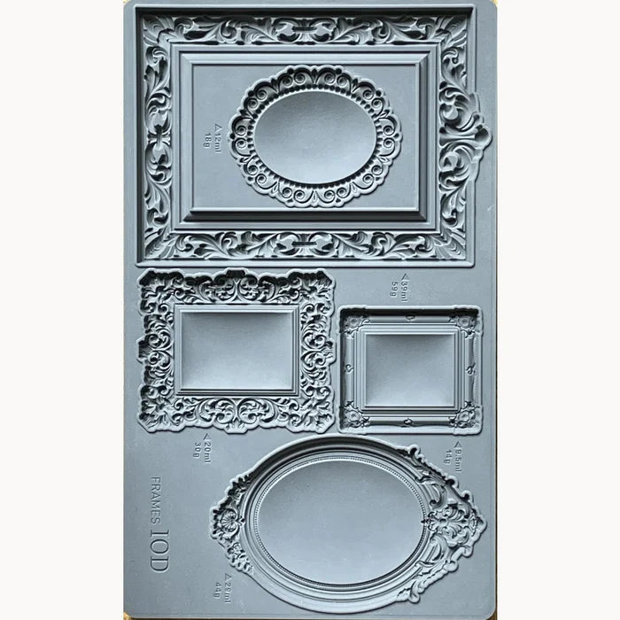 Decorative frame mold with intricate designs on a white background