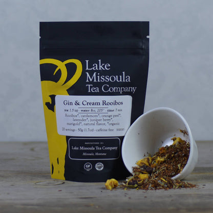 Lake Missoula Tea Company Gin & Cream flavored tea in a tea bag, with dried tea leaves and aroma visible.