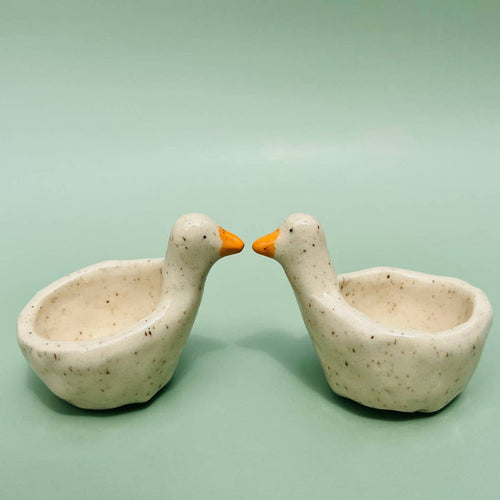 Goose-shaped ring dish with two speckled ceramic bowls and orange beaks for rings