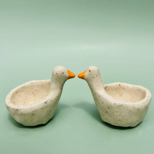 Goose-shaped ring dish with two speckled ceramic bowls and orange beaks for rings