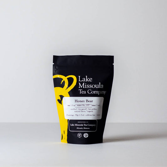 Lake Missoula Tea Company Honey Bear tea in a package with a honey bear illustration, showcasing a soothing tea blend.
