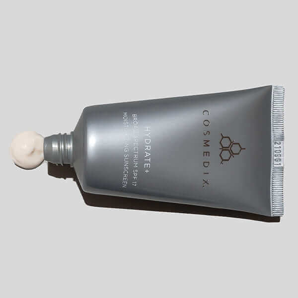 Cosmedix Hydrate+ SPF 17 moisturizing sunscreen tube with cream at the nozzle