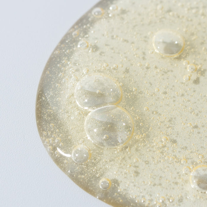 Close-up of a textured surface with bubbles on a light gray background