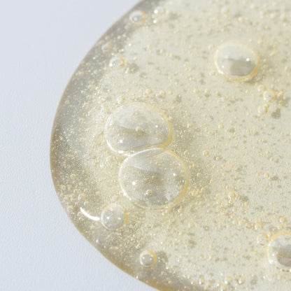 Close-up of a textured surface with bubbles on a light gray background