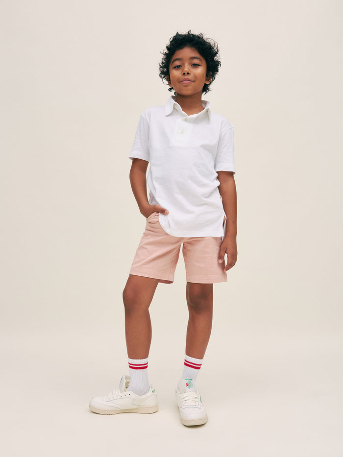 DL1961 boys' Jacob Short in dusty pink 'Rose Smoke' on boy with white polo, front standing view.