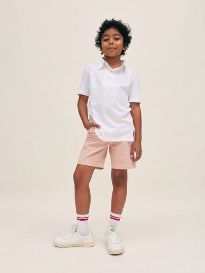 DL1961 boys' Jacob Short in dusty pink 'Rose Smoke' on boy with white polo, front standing view.