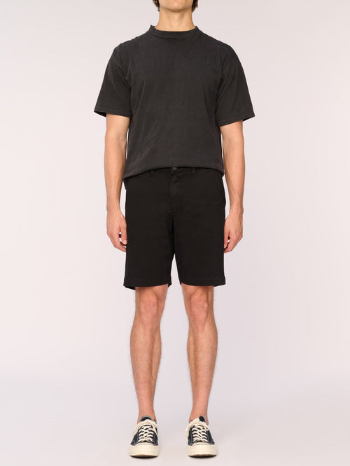 DL1961 men's Jake chino shorts in black, front view on model with faded black tee.