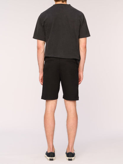 DL1961 men's Jake chino short in black, back view on model showing welt pockets.