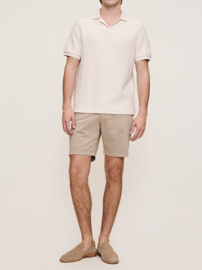 DL1961 men's Jake chino shorts in tan 'Soft Beige', front view on model with cream polo.