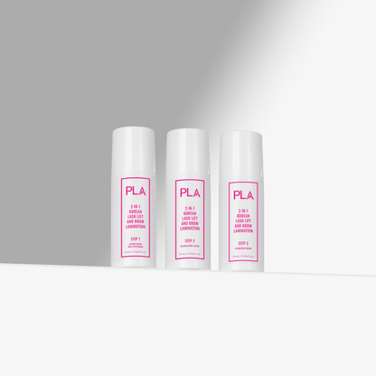 Three white cylindrical bottles with pink labels on a gray background
