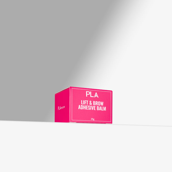 Pink box labeled 'PLA Lift & Brow Adhesive Balm' on a gray background