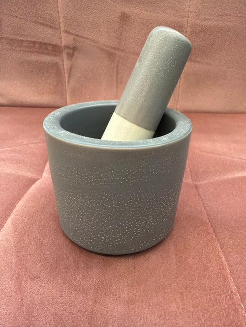 Large mortar and pestle dish by A Sparkling Mess, showing a sturdy stone pestle inside a deep ceramic mortar for grinding spices.