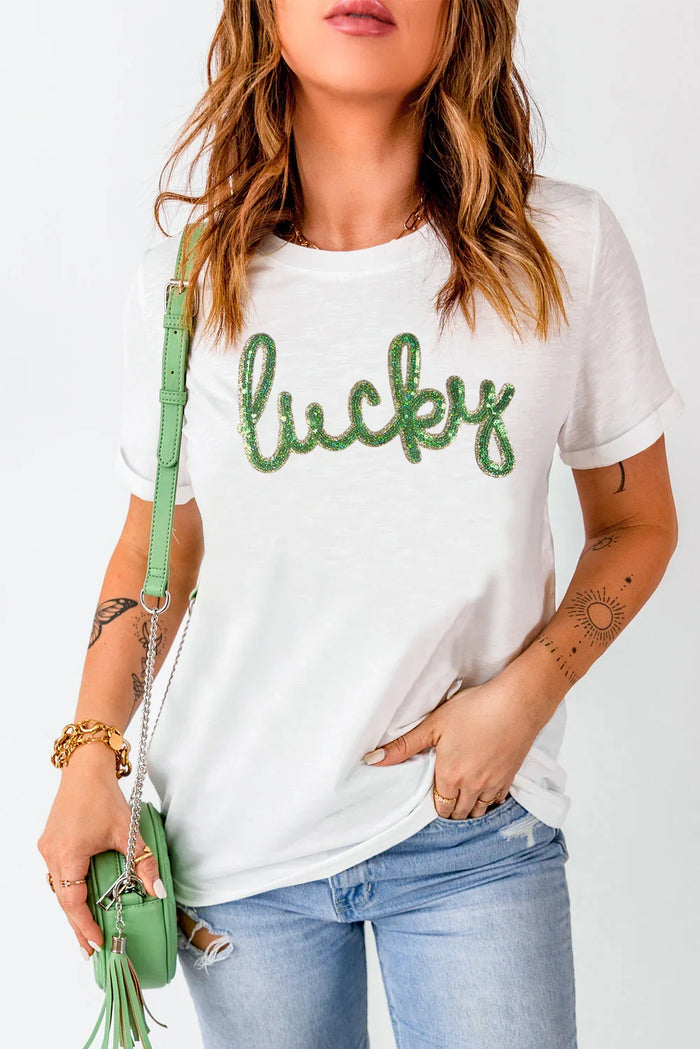 Woman wearing a white t-shirt with 'lucky' text, holding a green purse on a white background