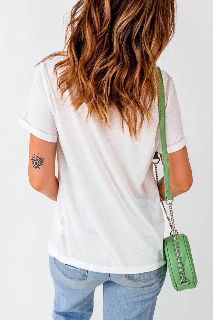 Person wearing a white t-shirt and blue jeans with a green handbag on a white background