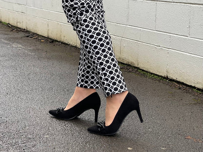 Comfortable, quality European women's stiletto sandal in suede leather. Quirky chain link detailing across the toe bar. Wedding or special occasion shoe in black.