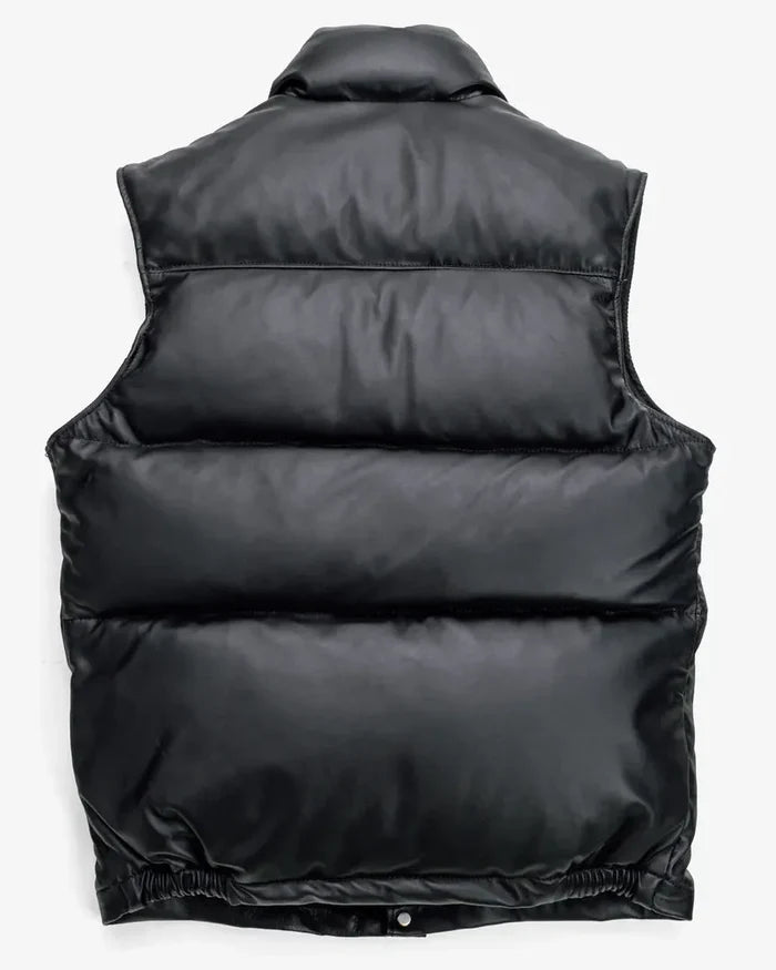 back showcase of the Leveljacket Matte Black leather quilted puffer vest, detailing its wide horizontal thermal baffles, high insulated stand-up collar, front vertical zipper pockets, snap-button closure placket, and elasticated lower back hem.