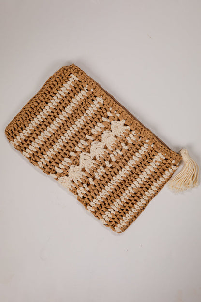 Knitted pouch with a tassel on a light gray background
