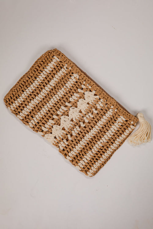 Knitted pouch with a tassel on a light gray background