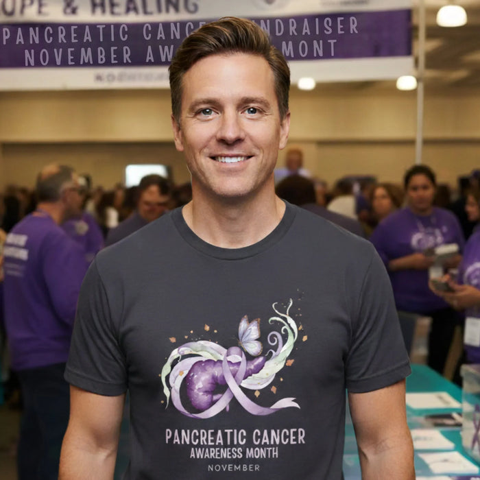 Man wearing a t-shirt with pancreatic cancer awareness design at an event.