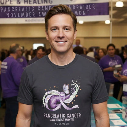Man wearing a t-shirt with pancreatic cancer awareness design at an event.