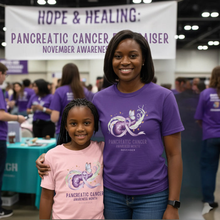 Two people wearing purple shirts with pancreatic cancer awareness designs at an event.