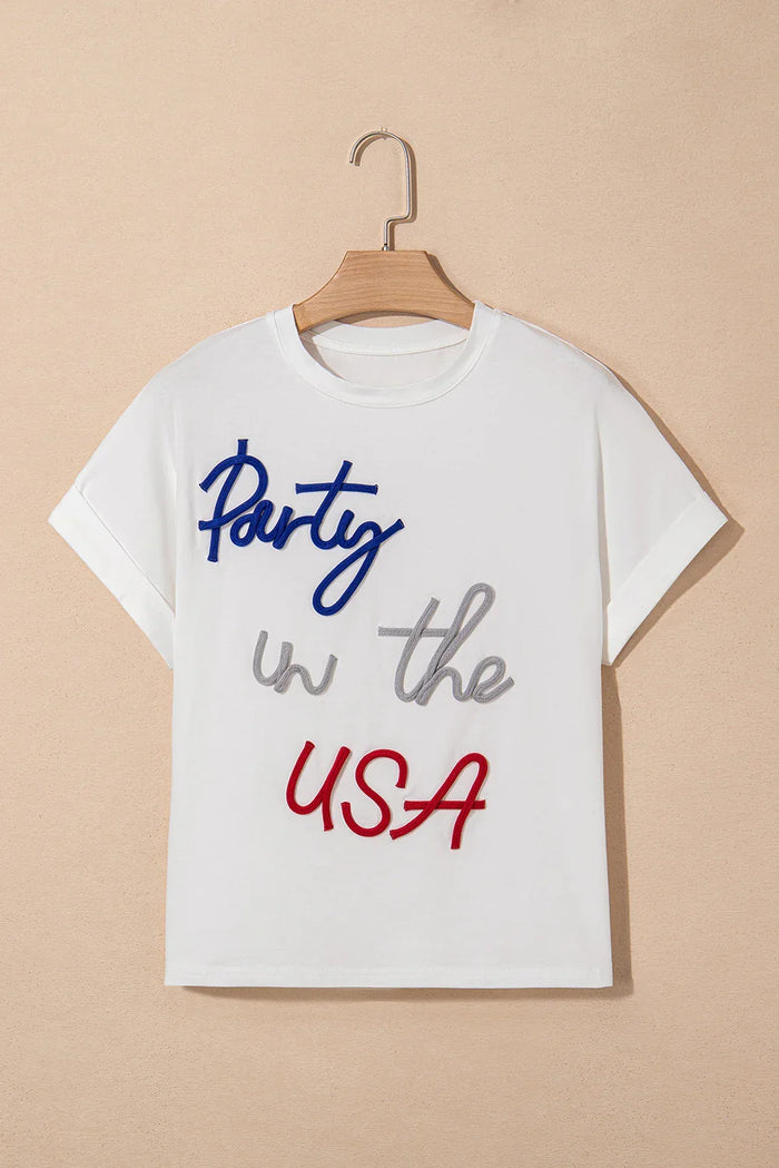White t-shirt with 'Party in the USA' text on a beige background
