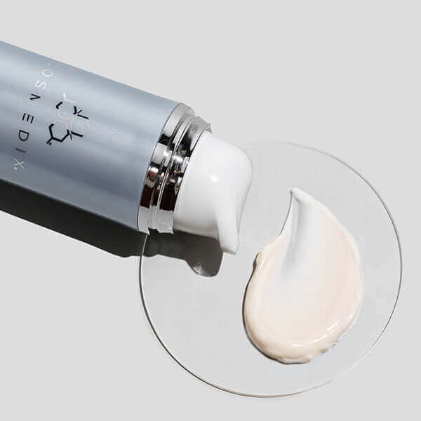 Peptide-Rich Defense  SPF 5) with light orange swatch against white background and glass dish