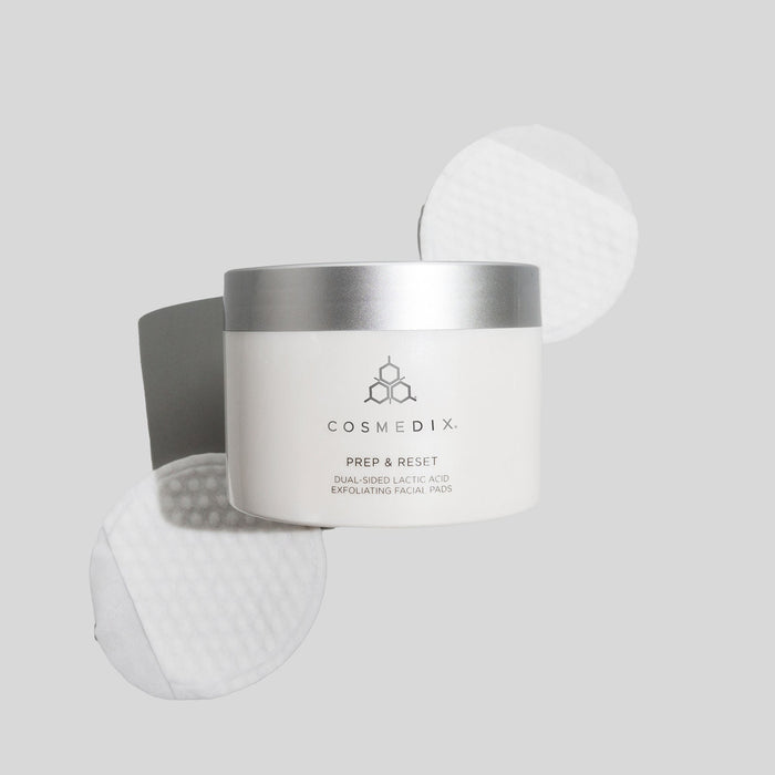 Cosmedix Prep & Reset jar with a white exfoliating pad visible beside the container