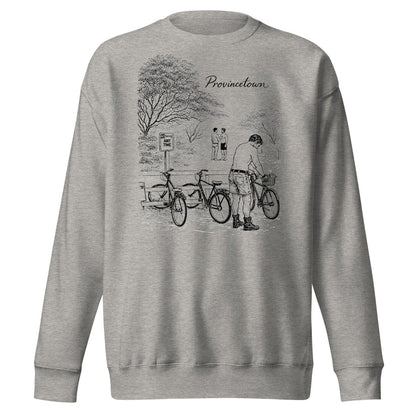 A light heather gray crewneck sweatshirt featuring a black line art graphic of a cyclist in a park with the word 'Provincial' printed above, shown against a plain white background.