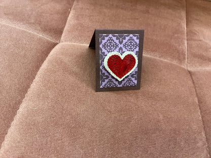 Colorful quilled heart pin from Cat's Quilling featuring intricate paper coil design, perfect as a decorative accessory.