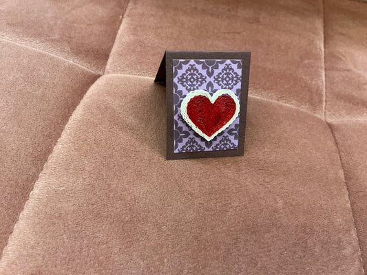 Colorful quilled heart pin from Cat's Quilling featuring intricate paper coil design, perfect as a decorative accessory.