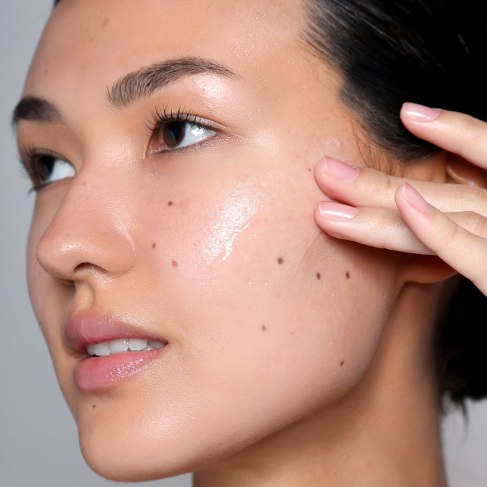 Close-up of a woman's face showing dewy hydrated skin as a result of Reboot Overnight Hydration Complex