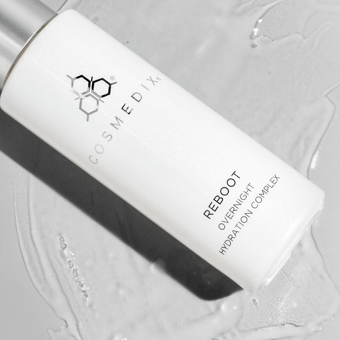 Monochrome close up of Reboot Overnight Hydration Complex bottle with COSMEDIX branding