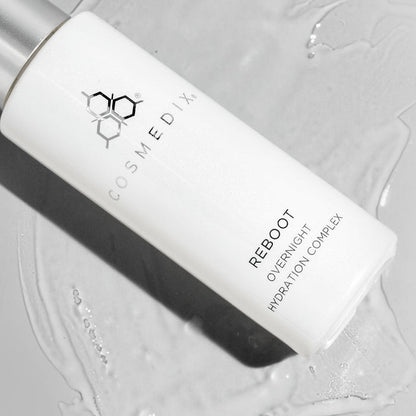 Monochrome close up of Reboot Overnight Hydration Complex bottle with COSMEDIX branding