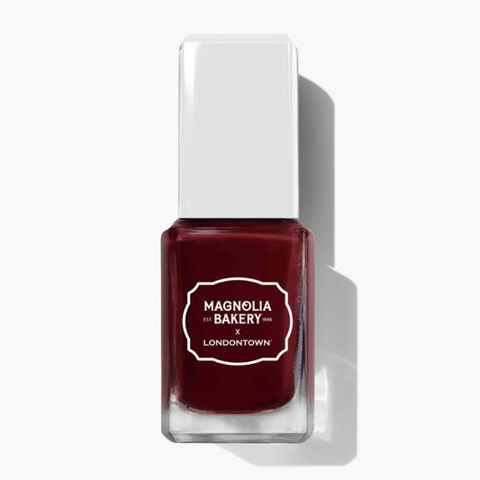 A bottle of rich, deep burgundy nail polish labeled “Red Velvet by LONDONTOWN” stands upright on a white background with a shadow to the right.