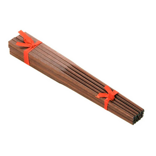 Wooden chopsticks tied with red ribbons on a white background