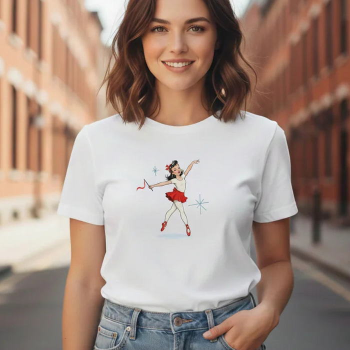 Woman wearing a white t-shirt with a graphic design on a city street.
