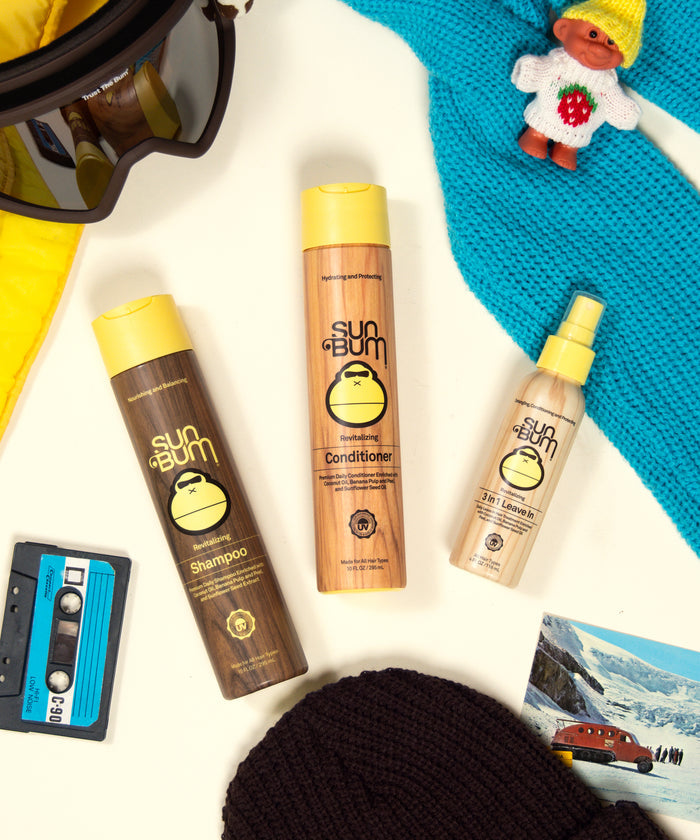Sun Bum Revitalizing Hair Care Bundle with shampoo, conditioner, and 3-in-1 leave-in spray in colorful setup