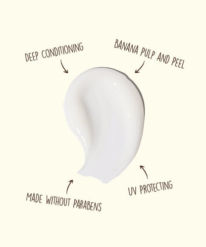 White cream smear with text annotations highlighting deep conditioning, banana pulp and peel, UV protecting, and made without parabens features.