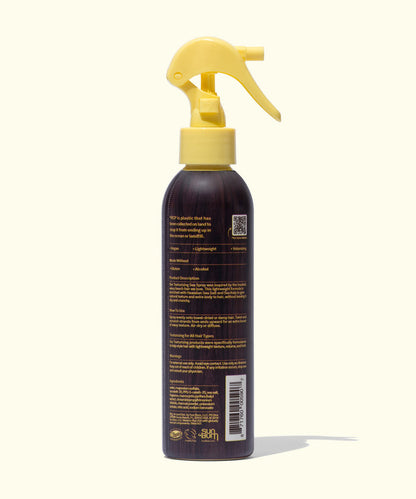 Back view of Sun Bum Sea Spray in a brown bottle with a yellow spray nozzle on a light background