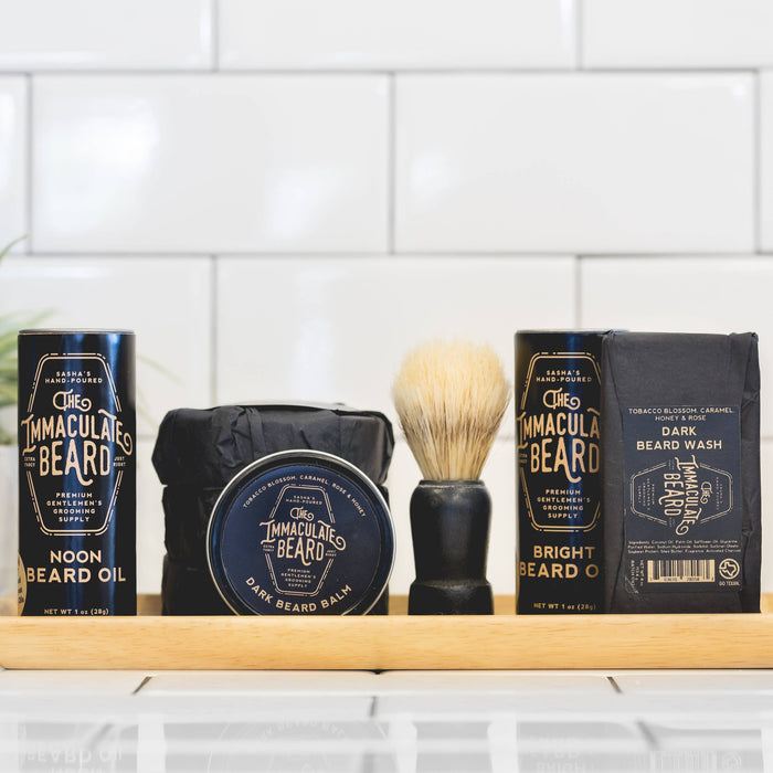 The Immaculate Beard shave soap puck with a smooth, rounded surface in a black container, ready for grooming.