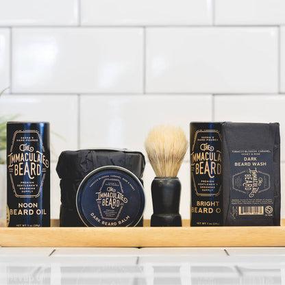 The Immaculate Beard shave soap puck with a smooth, rounded surface in a black container, ready for grooming.