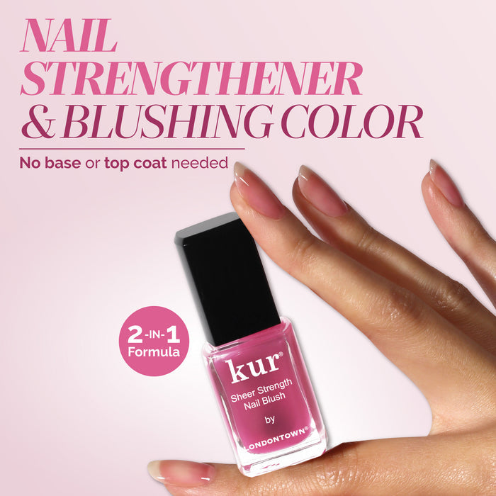 A hand with manicured nails holds a bottle of LONDONTOWN Sheer Strength Nail Blush - Hibiscus, a 2-in-1 nail hardener and blushing color that strengthens nails while adding a glow-boosting pink tint.
