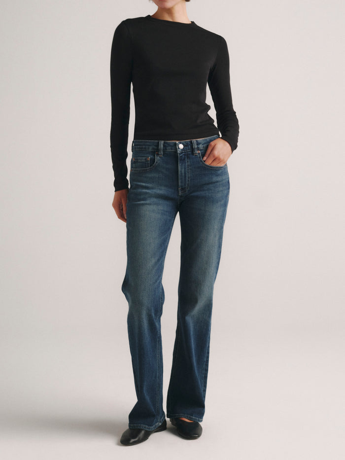 DL1961 Shrunken Tee long-sleeve in black with blue jeans, full-length front view.