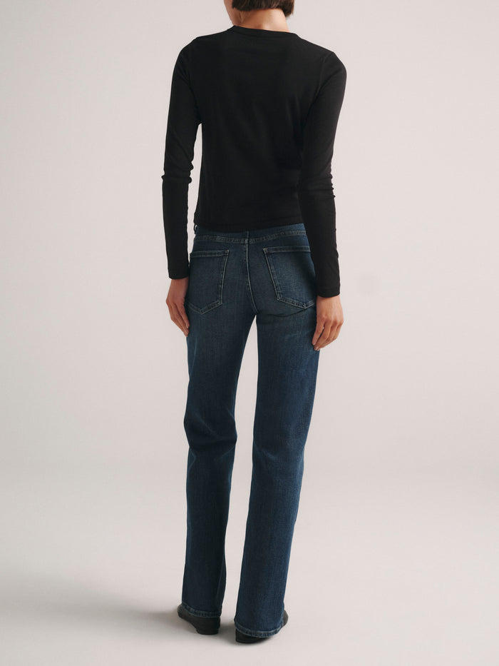 DL1961 Shrunken Tee long-sleeve in black with blue jeans, full-length back view.