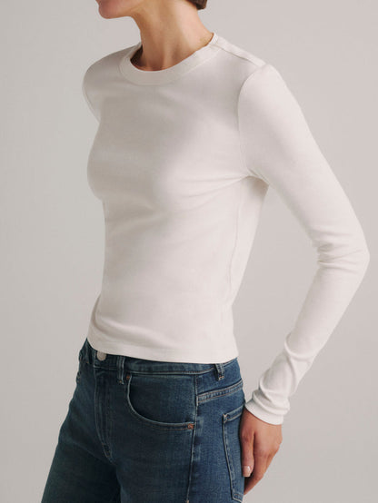 DL1961 Shrunken Tee long-sleeve in white, fitted crew-neck top with blue jeans, three-quarter view.