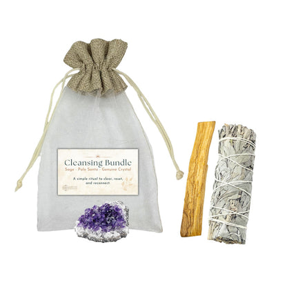 Cleansing bundle with sage, Palo Santo, and amethyst crystal on a white background