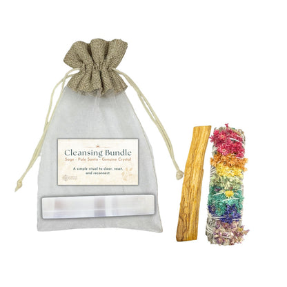 Cleansing bundle with sage, Palo Santo, and rainbow-colored crystals in a drawstring bag on a white background.