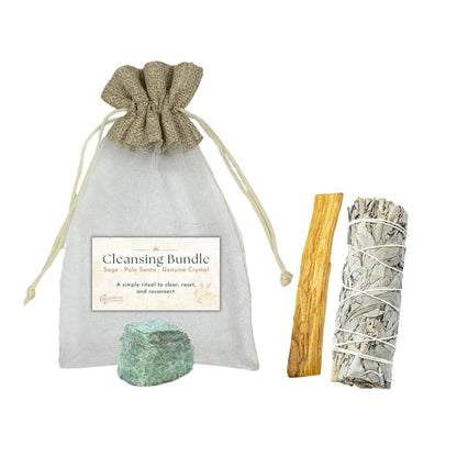 Cleansing bundle with sage, Palo Santo, and crystal in a drawstring bag on a white background